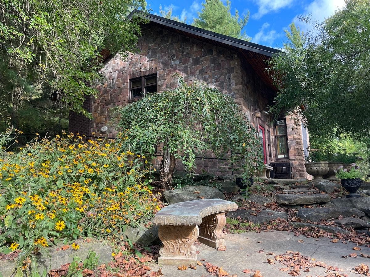 View of the cabin during the summer with the daisy garden adding interest